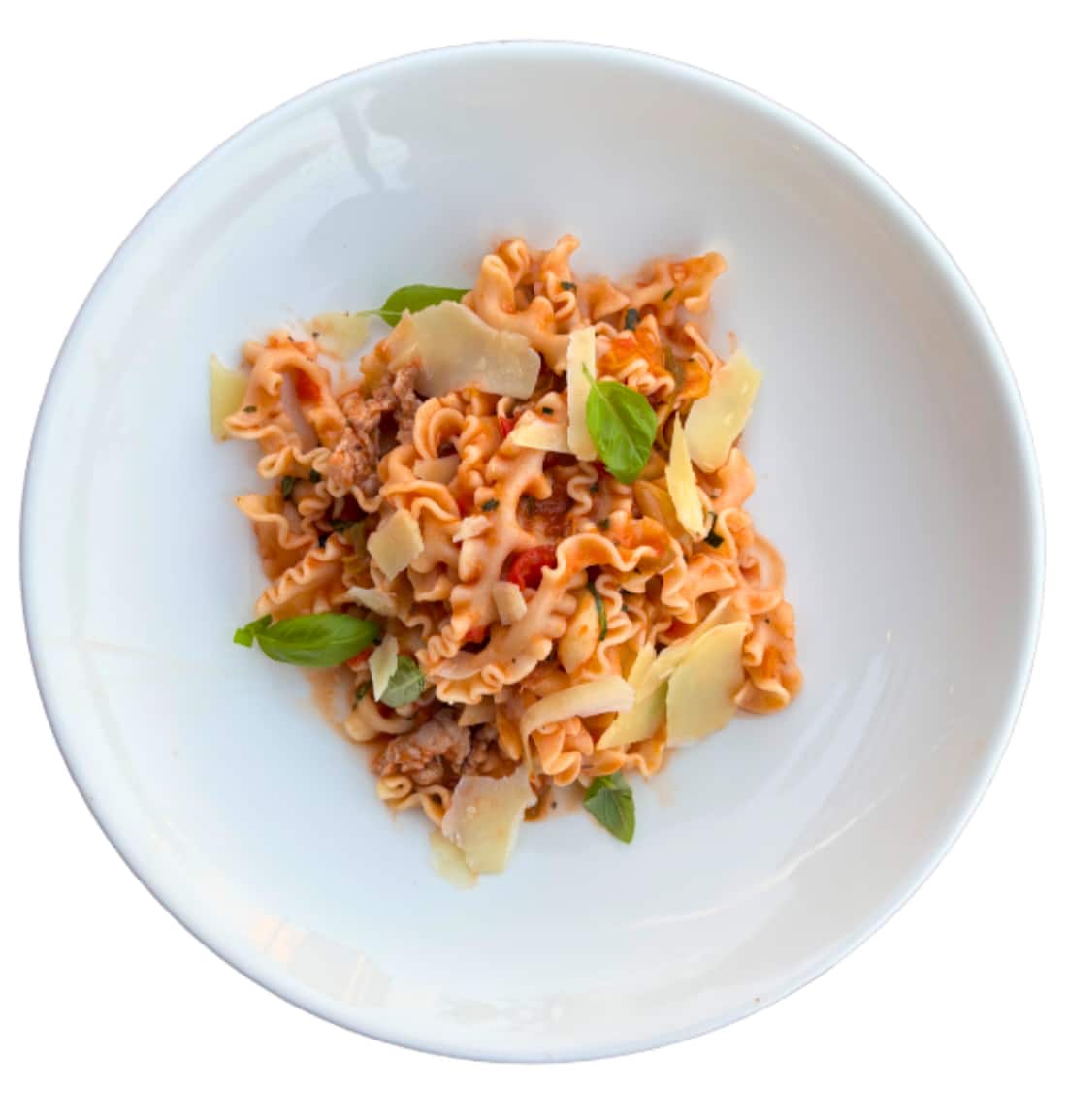 Madalfine Pasta with Pork and Fennel Sausage Cooked sourdough mafaldine pasta served with rich tomato sauce, pork and fennel sausage, fresh basil, and shaved parmesan on a white plate