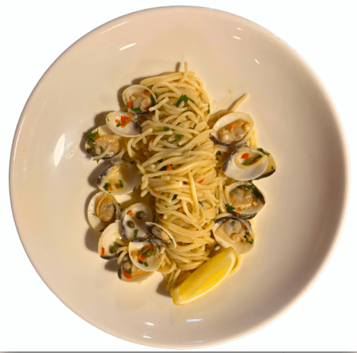 Sourdough spaghetti with clams in white wine garlic sauce, plated for restaurant service